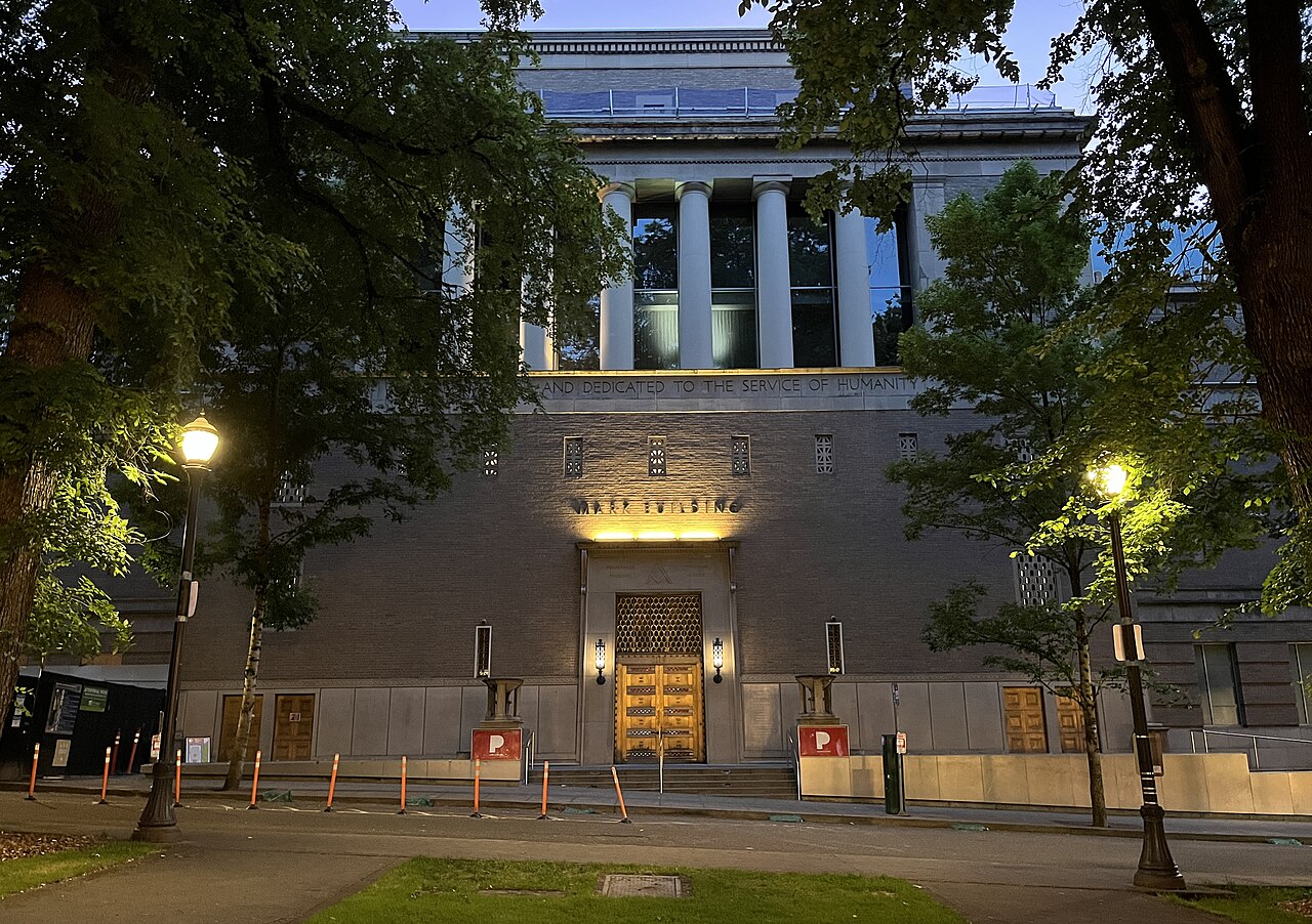The Portland Art Museum's columned Mark Building facade, lit at dusk on the downtown South Park Blocks